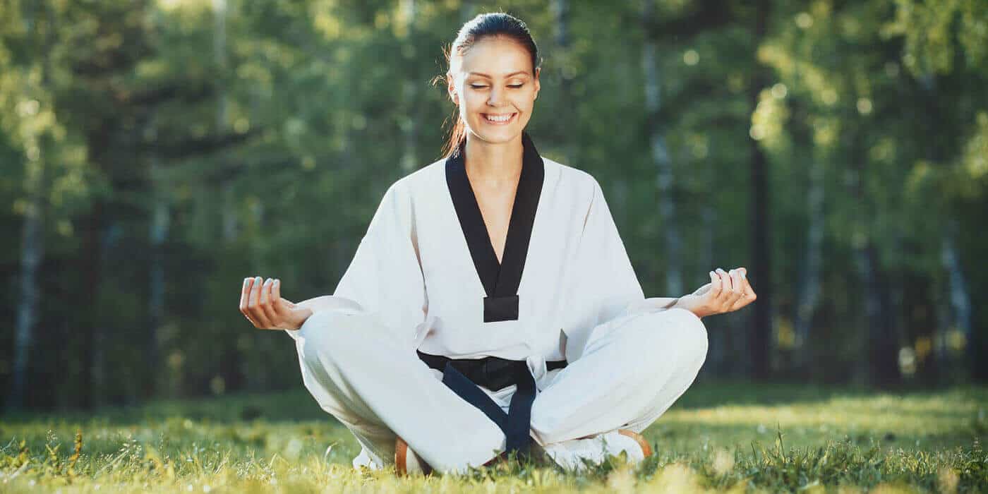 Martial Arts Lessons for Adults in Forney TX - Happy Woman Meditated Sitting Background